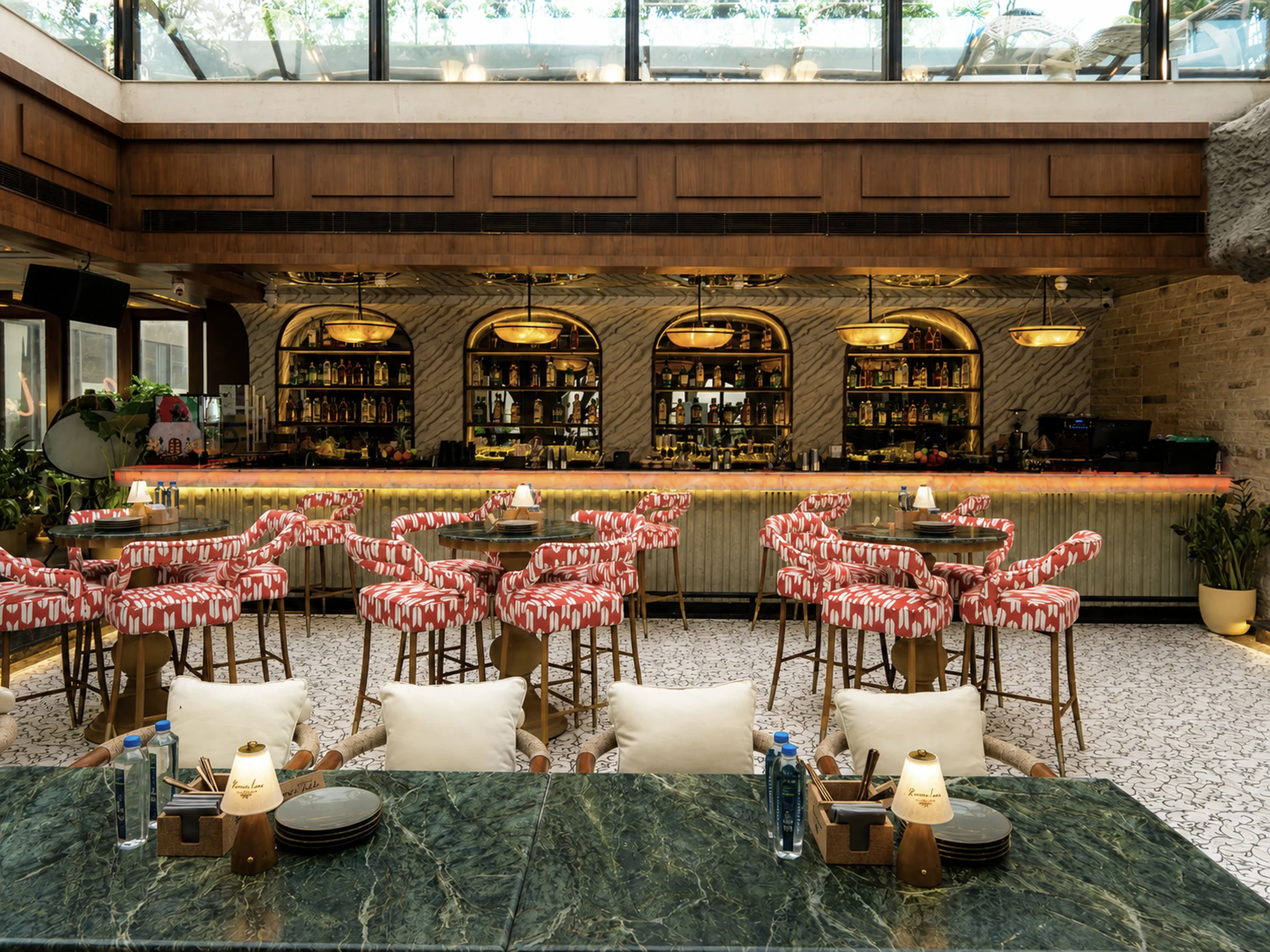 The bar seen across a green marble table