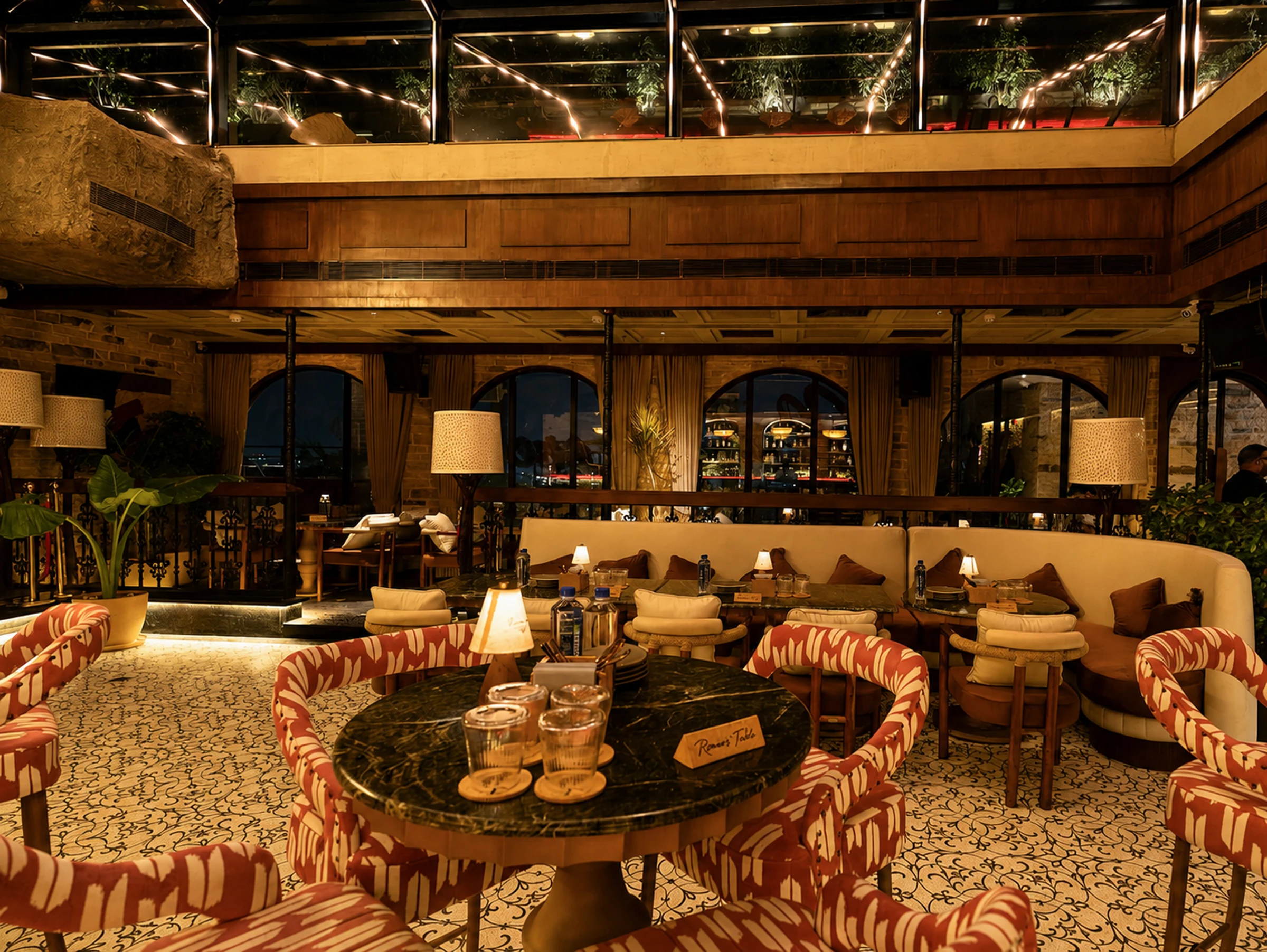 A round marble table before the curved banquette