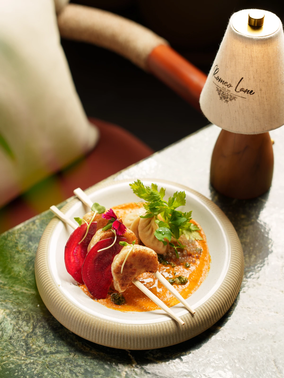 A small plate beside the table lamp