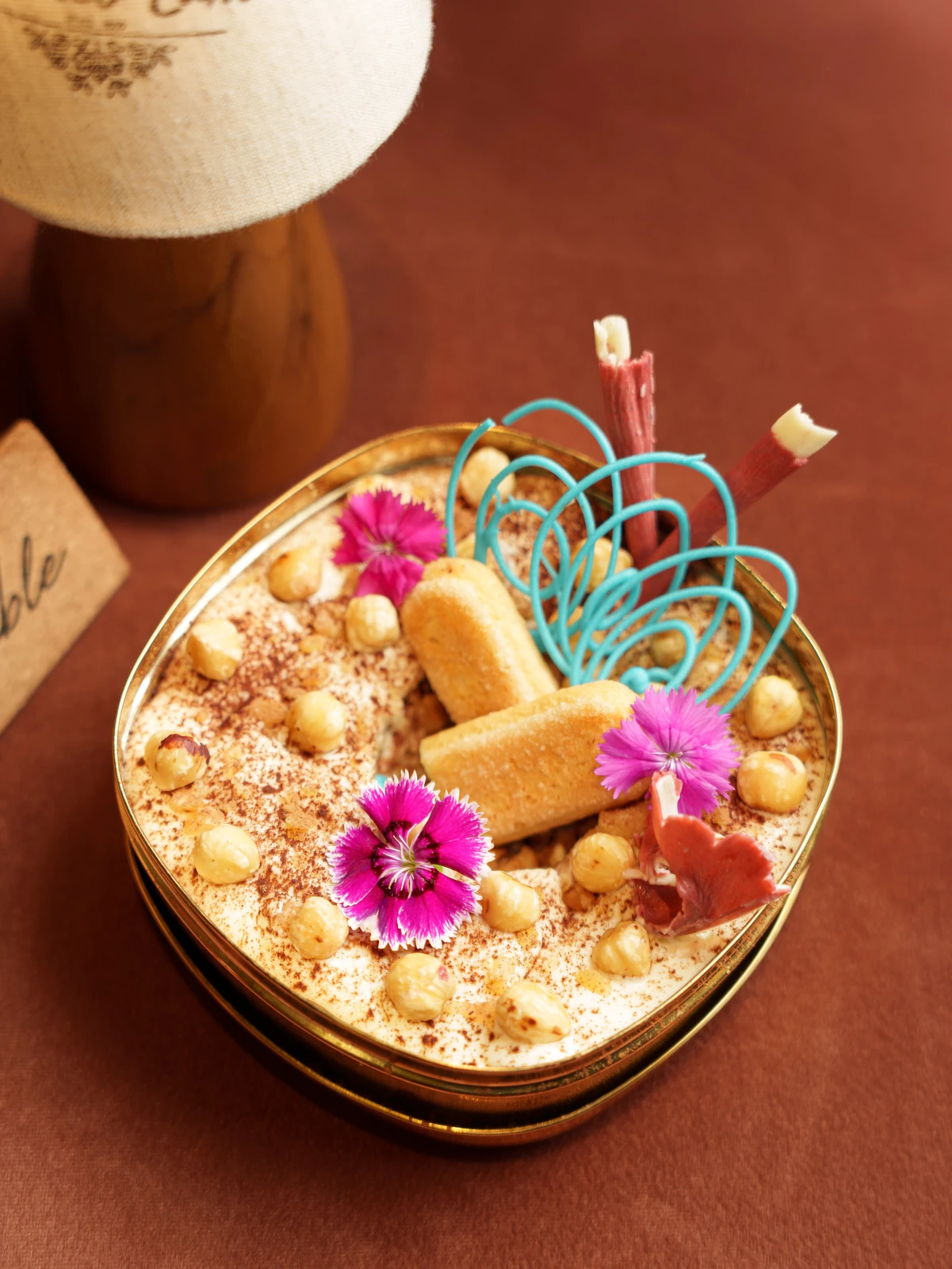 A dessert in a brass dish, sugar-work on top