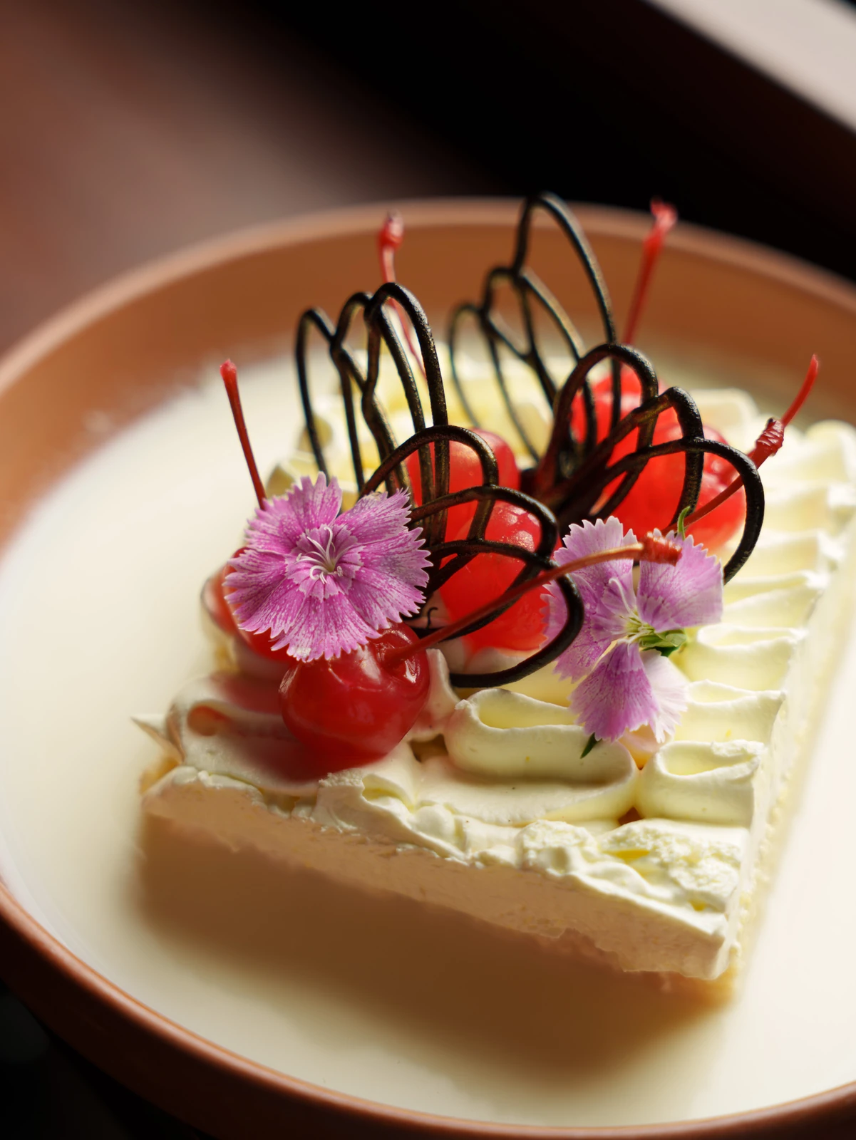 A milk-soaked cake with chocolate sugar-work