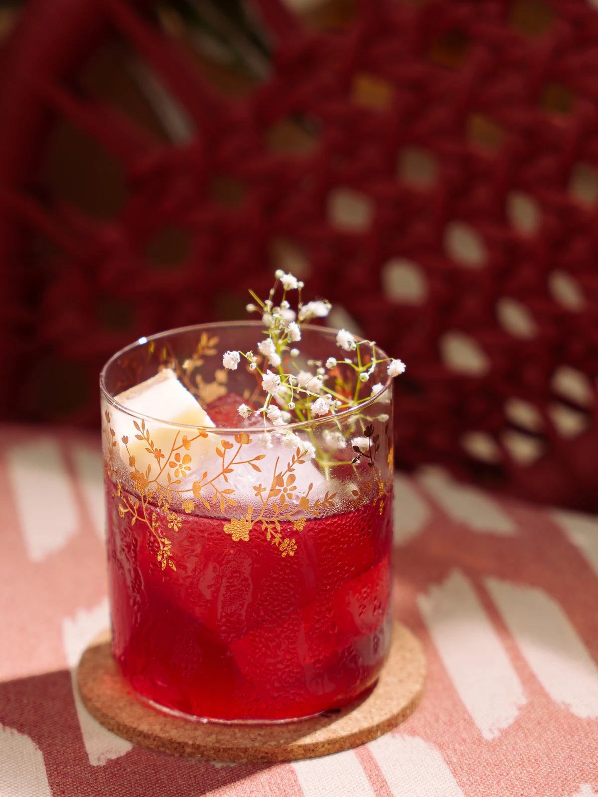 A red cocktail on the ikat
