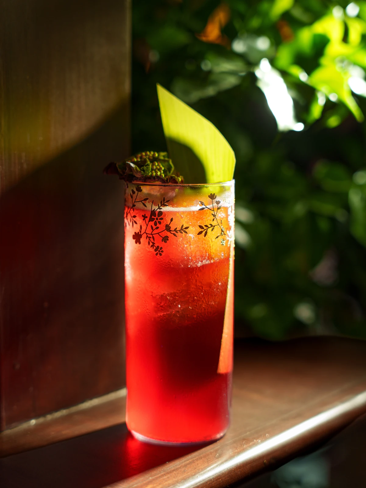 A tall red cocktail in the sun