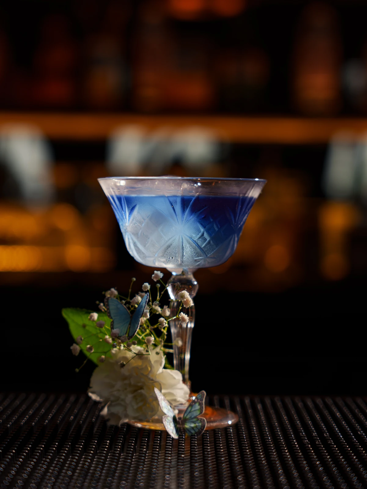 A blue coupe on a crystal stem