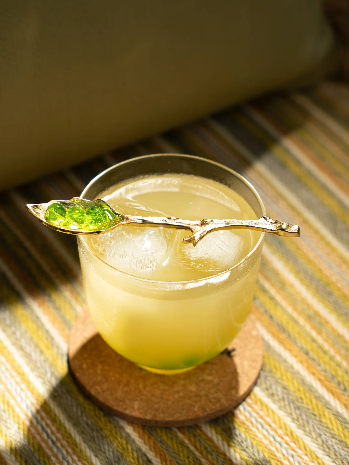 A golden cocktail on the striped table