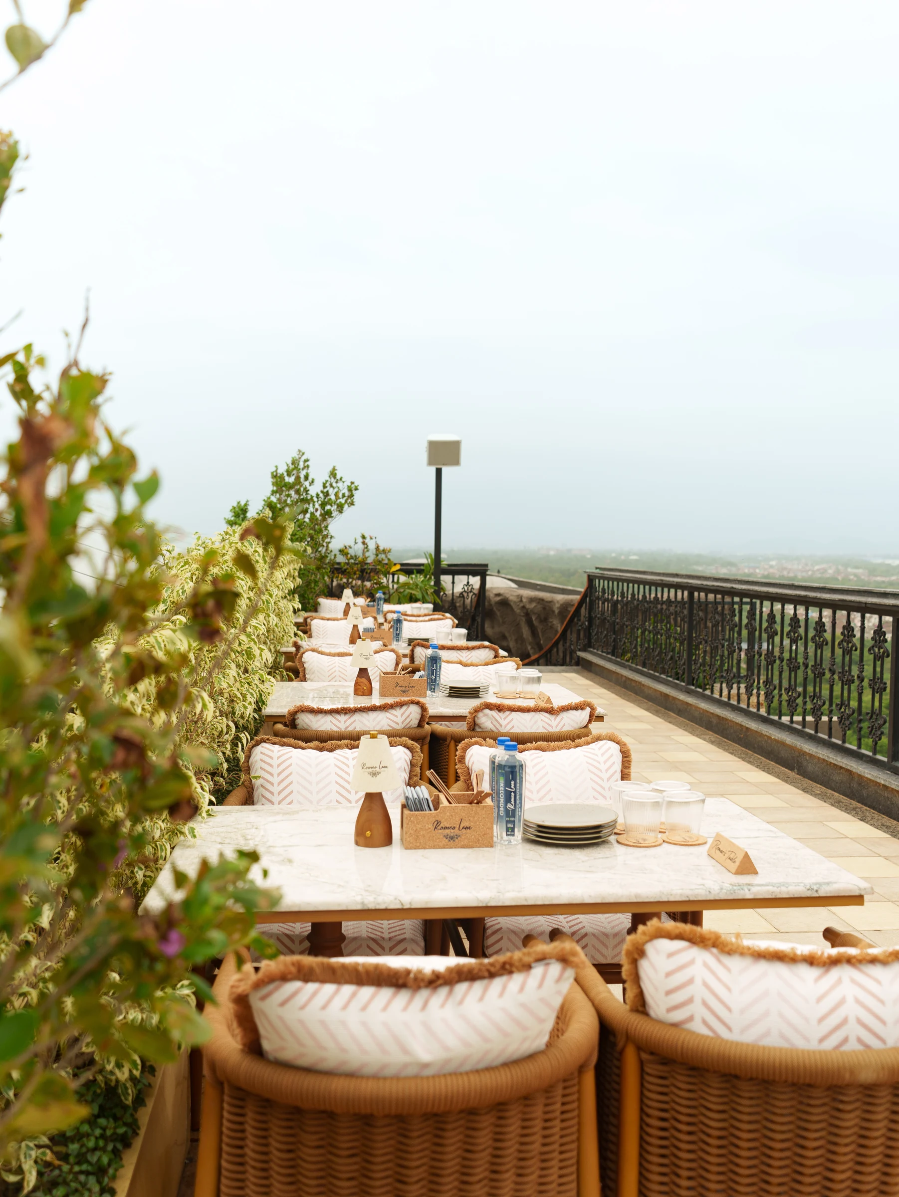 Marble tables along the terrace railing
